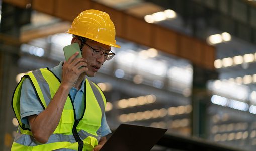 Male engineer calling on the phone at construction site